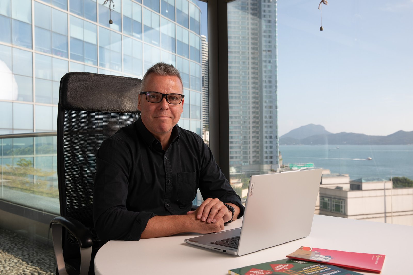 A man sitting at a desk with a laptop.